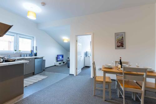 a kitchen and dining room with a table and a dining room at The Eldern - Spacious, Netflix, free Parking, close to A1 in Peterborough
