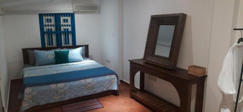 a bedroom with a bed and a mirror and a table at Alakamandava in Colombo