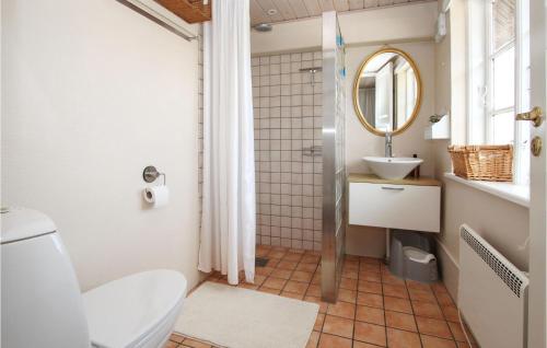 a bathroom with a toilet and a sink and a mirror at Amazing Home In Sams With Wifi in Nordby
