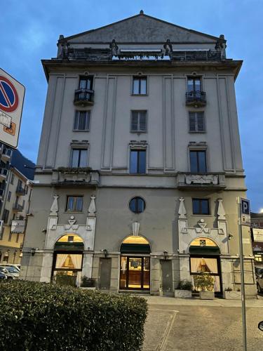 a large white building with a clock tower at Il Vecchio Borgo Relais in Como