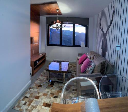 a living room with a couch and a table at Nievemar Edificio Monte Oiz in Sierra Nevada