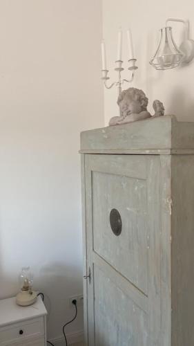 a teddy bear sitting on top of a wooden cabinet at Dom Anna in Pisz