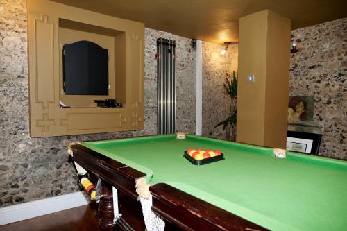 a room with a pool table in a room at Luxury 9 Bed Manor House Hot Tub Cinema Room SkyTV in Saffron Walden