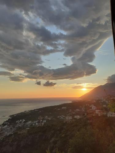 a view of the sun setting over the ocean at XHEKO ROOMS in Dhërmi