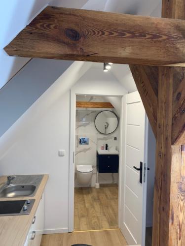 a bathroom with a sink and a toilet at Zacisze Nest - noclegi blisko plaży in Mielno