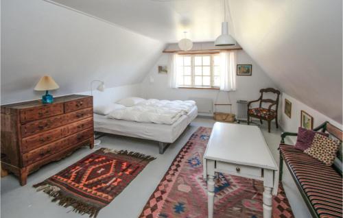 a bedroom with a bed and a table and a couch at Stunning Home In Sams With Wifi in Nordby
