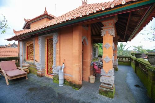a small house with a chair in front of it at Gayatri in Ubud
