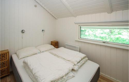 a bedroom with a bed in a room with a window at Cozy Home In Sams With Kitchen in Kolby Kås