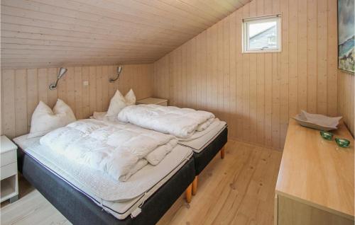 a bedroom with a large bed in a room at Stunning Home In Samsø With Sauna in Ballen