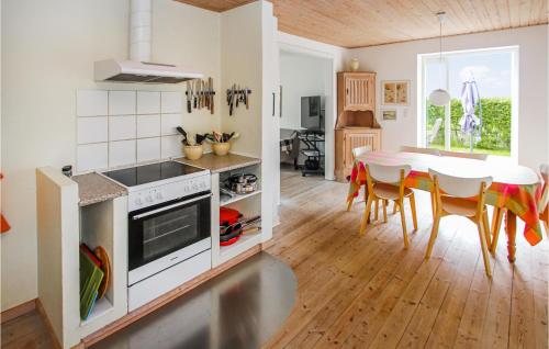 a kitchen and dining room with a table and chairs at 3 Bedroom Gorgeous Home In Samsø in Ballen