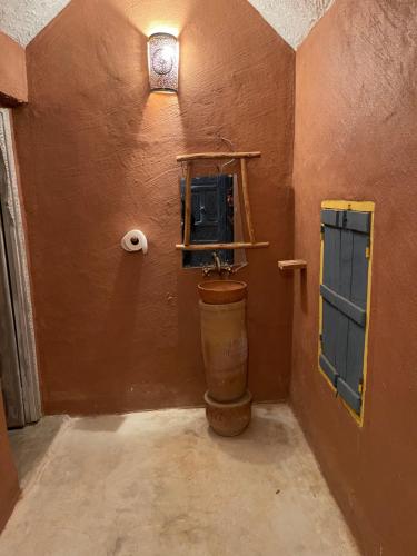 a bathroom with a toilet and a sink in a room at Ryad lcaid in Tissint