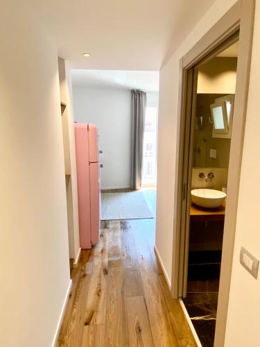 a kitchen with a pink refrigerator and a sink at WeLive Trapani - luxury apartments in Trapani
