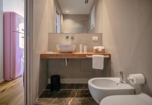 a bathroom with a sink and a bowl sink at WeLive Trapani - luxury apartments in Trapani