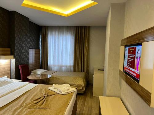 Katil atau katil-katil dalam bilik di Grand Ezel Hotel