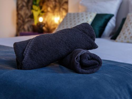 a towel is laying on top of a bed at LE CONCORDE-WIFI-Clim-Parking-3étoiles-OcKeys in Bram