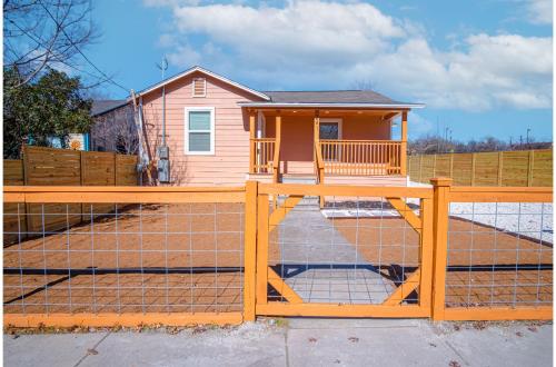 a wooden fence in front of a house at Adorable 4BR 2BA Close to Riverwalk and Downtown in San Antonio