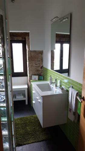 a bathroom with a sink and a mirror at TOURON Nº1 in Carballedo