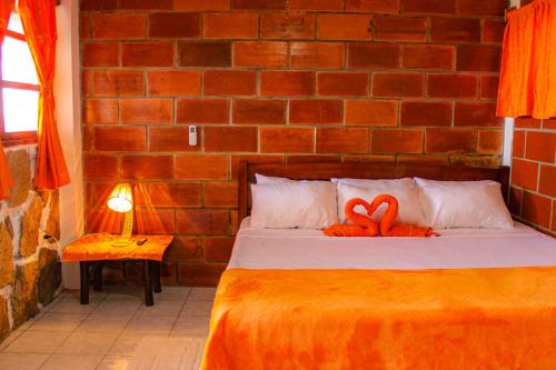 a bedroom with a bed with a red toy on it at HANGA ROA HOTEL in Montañita