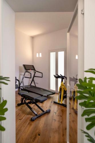 an empty room with a gym with two exercise bikes at WeLive Trapani - luxury apartments in Trapani