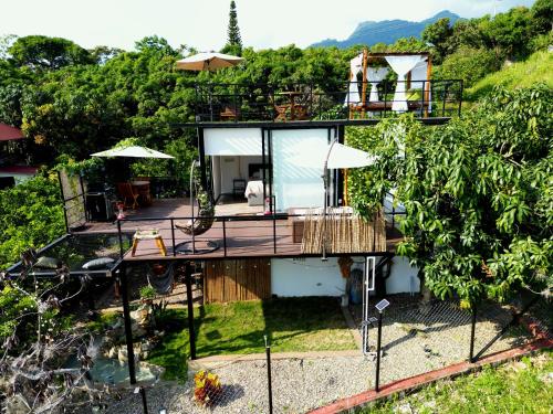 a house on a hill with a deck and a patio at Oasis Glamping Tena Cundinamarca Cerca a Bogotá in Tena