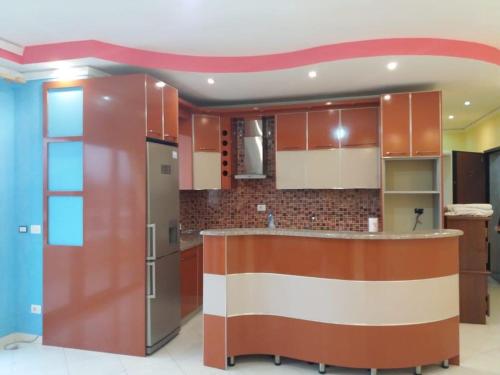 a kitchen with brown cabinets and a counter top at LUX SEAVIEW APARTMENT in Vlorë