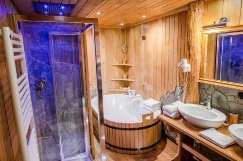a bathroom with a tub and a sink and a shower at Grand Hotel Sestriere in Sestriere