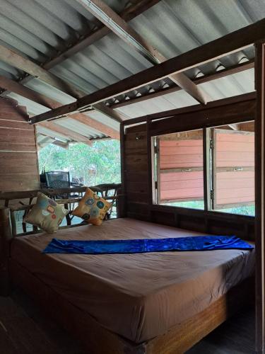 a large bed in a room with a roof at Big Hug Home in Ko Yao Noi