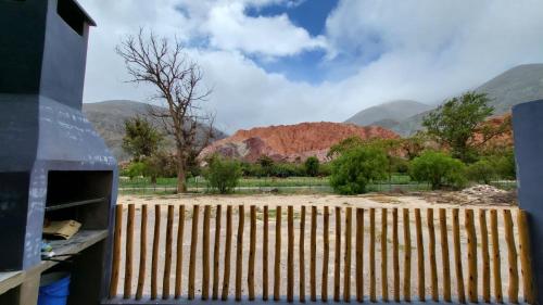 a view of the desert through a wooden fence at Imagine duplex in Purmamarca