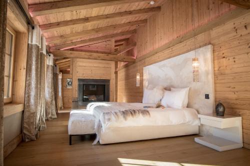 a bedroom with two beds in a room with wooden walls at Grand Chalet de Rougemont in Rougemont