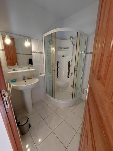 a bathroom with a shower and a toilet and a sink at Saint François Villacoco in Saint-François