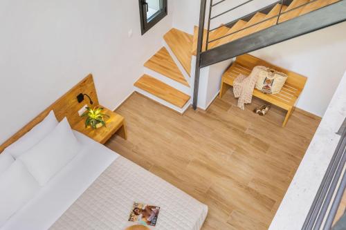 an overhead view of a room with a bed and stairs at AlexMare Hotel Fourka in Skála Foúrkas