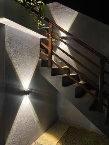 a set of stairs with lights on the wall at Jungle Escape Hiriketiya in Hiriketiya