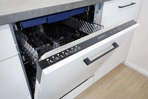 a dish washer and dryer in a kitchen drawer at Aparthotel Na Klenici in Mladá Boleslav