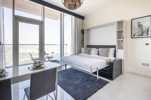 a bedroom with a bed and a table and a desk at Miraclz Skyline Tower in Dubai