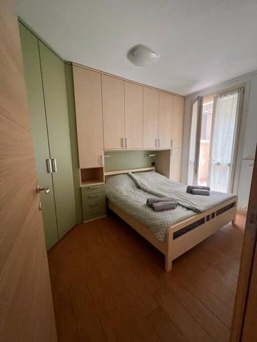a bedroom with a bed and a large window at Csendes és nyugodt hely medencével. in Parzanica