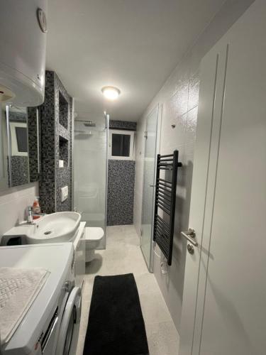 a bathroom with a sink and a toilet and a shower at Amigi in Sarajevo