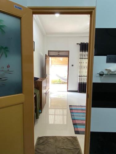 a room with a door open to a room with a hallway at Villa Sun Rising in Talpe