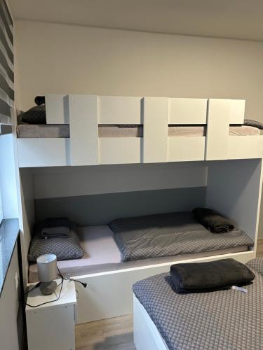 two bunk beds in a room with a bed at Apartmani "Stari Grad - Samobor" in Samobor