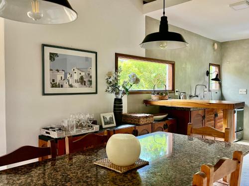 a kitchen with a table and a counter top at Casa Dash Beach Houses in Punta del Este