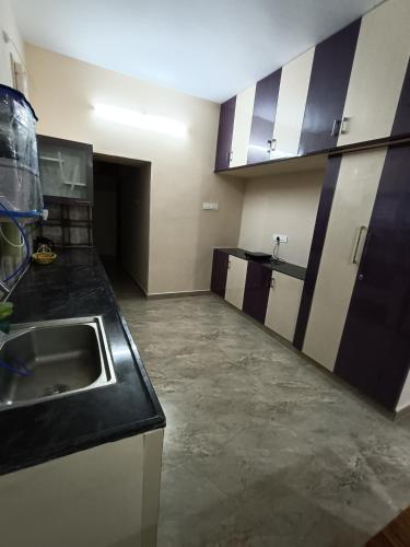 a kitchen with a sink and a counter at Doctor's Homestay in Tiruvannāmalai