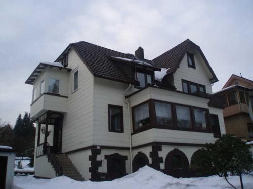 a large house with snow in front of it at Ferienwohnung Lautenbach in Bad Sachsa