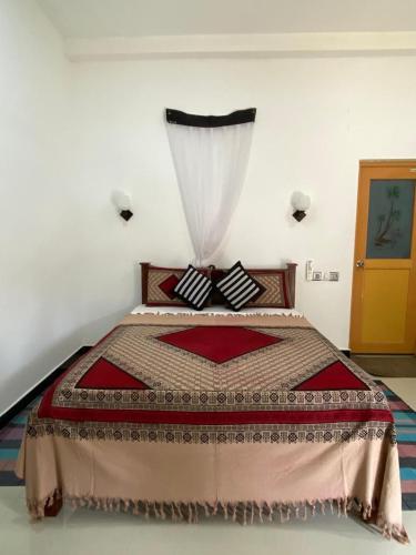 a bedroom with a large bed with a curtain at Villa Sun Rising in Talpe
