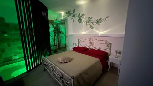 a bedroom with a bed with red pillows next to a window at Lemon Suite-Luxury in Cellino San Marco