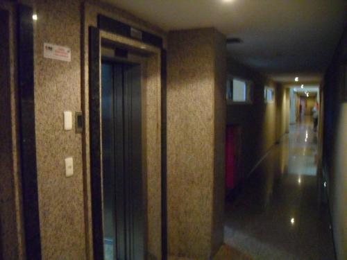 a hallway in a building with a door open at Suites Vila de Iracema in Fortaleza