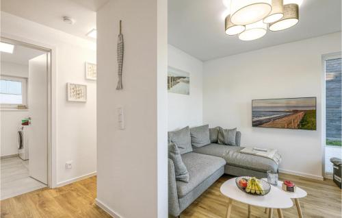 a living room with a couch and a table at Awesome Home In Tossens With Kitchen in Tossenserdeich