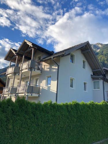 a white building with balconies on the side of it at Appartment Isabelle Sky in Presseggersee