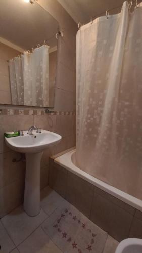 a bathroom with a sink and a tub and a shower at Depto calle 18 - soleado y con balcon in La Plata