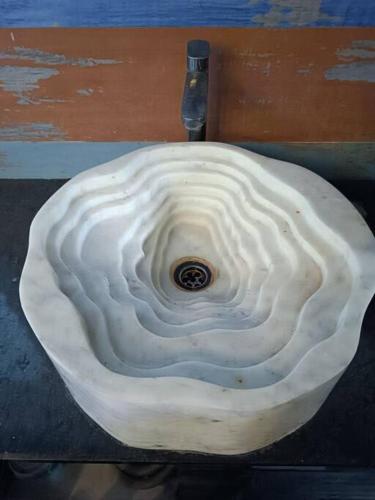 a white sink with a drain in the middle at Fancy and Modern Apartment in Patna