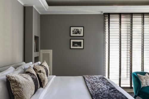 a bedroom with a large white bed with pillows at NAMAN HOTELLERIE - Spagna in Rome