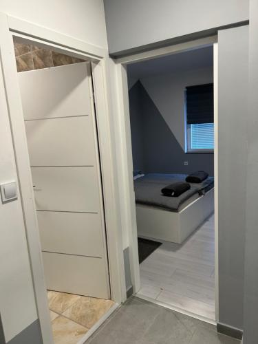a bedroom with a door leading to a bed at Apartmani "Stari Grad - Samobor" in Samobor